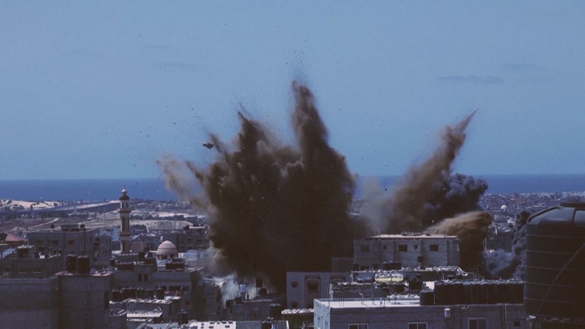 Israeli air strike hitting a targeted building in Rafah in the southern Gaza Strip, black smoke rising.