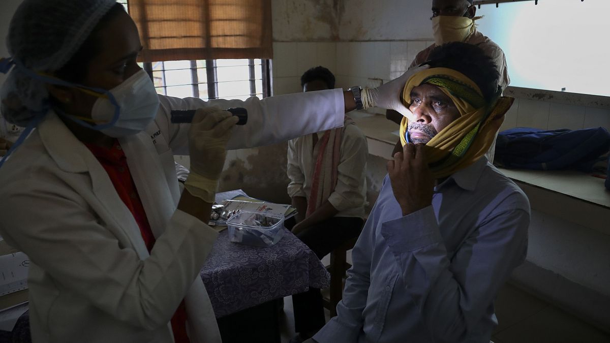 A doctor checks a man who recovered from COVID-19 and now infected with black fungus at the Mucormycosis ward of a hospital in Hyderabad, India, May 20, 2021