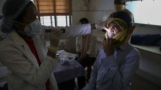 A doctor checks a man who recovered from COVID-19 and now infected with black fungus at the Mucormycosis ward of a hospital in Hyderabad, India, May 20, 2021