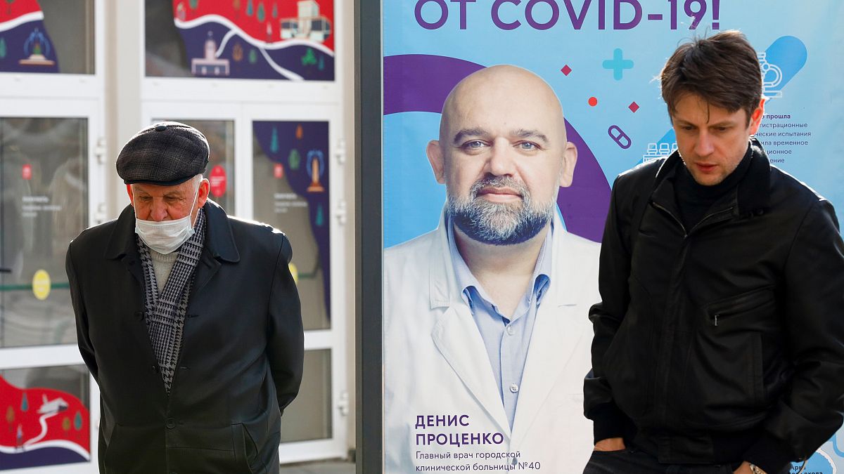 Moscow: poster showing a portrait of Dr. Denis Protsenko and words reading "Get vaccinated against covid-19!!"