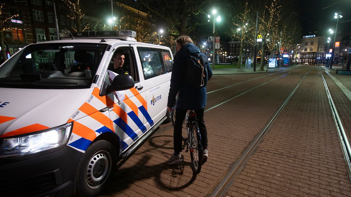 Dutch police  in the center of Amsterdam, Saturday, Jan. 23, 2021.