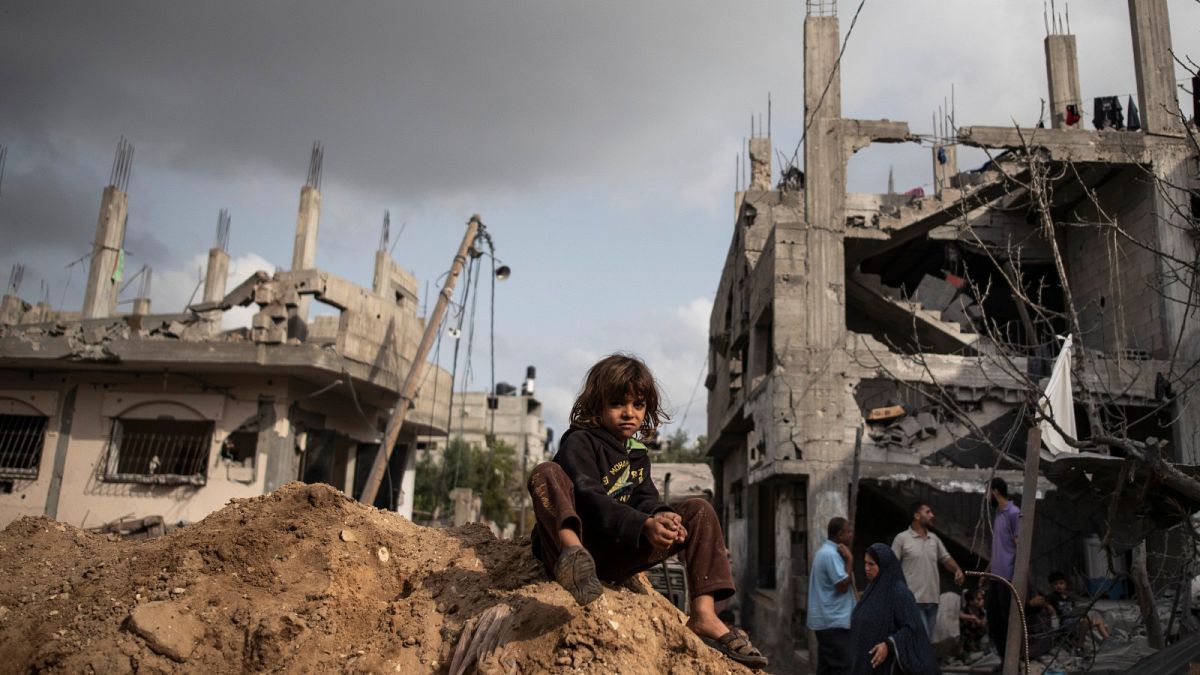 Palestinians in Beit Hanoun, northern Gaza Strip, inspect the damage to their homes following a cease-fire, Friday, May 21, 2021. (AP Photo/Khalil Hamra)
