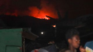 People flee as the night sky is turned red by the eruption of Mount Nyiragongo, in Goma, Congo, Saturday, May 22, 2021. 