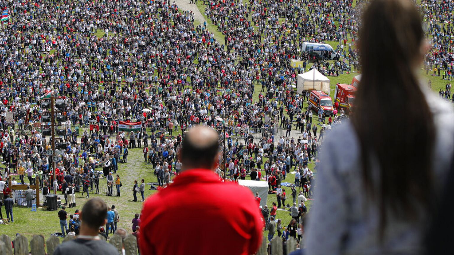 FILE- Catholic pilgrims fill the hillsides after tens of thousands joined their faith's biggest religious event in Sumuleu Ciuc, Romania, Saturday, May 22, 2021.