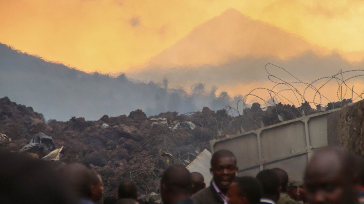 Residents check the damages caused by lava from the overnight eruption of Mount Nyiragongo, on the outskirts of Goma, Congo in the early hours of Sunday, May 23, 2021