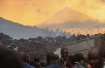 Residents check the damages caused by lava from the overnight eruption of Mount Nyiragongo, on the outskirts of Goma, Congo in the early hours of Sunday, May 23, 2021