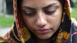 A woman from Afghanistan cries in the village of Bosanska Bojna, Bosnia, Saturday, May 22, 2021.