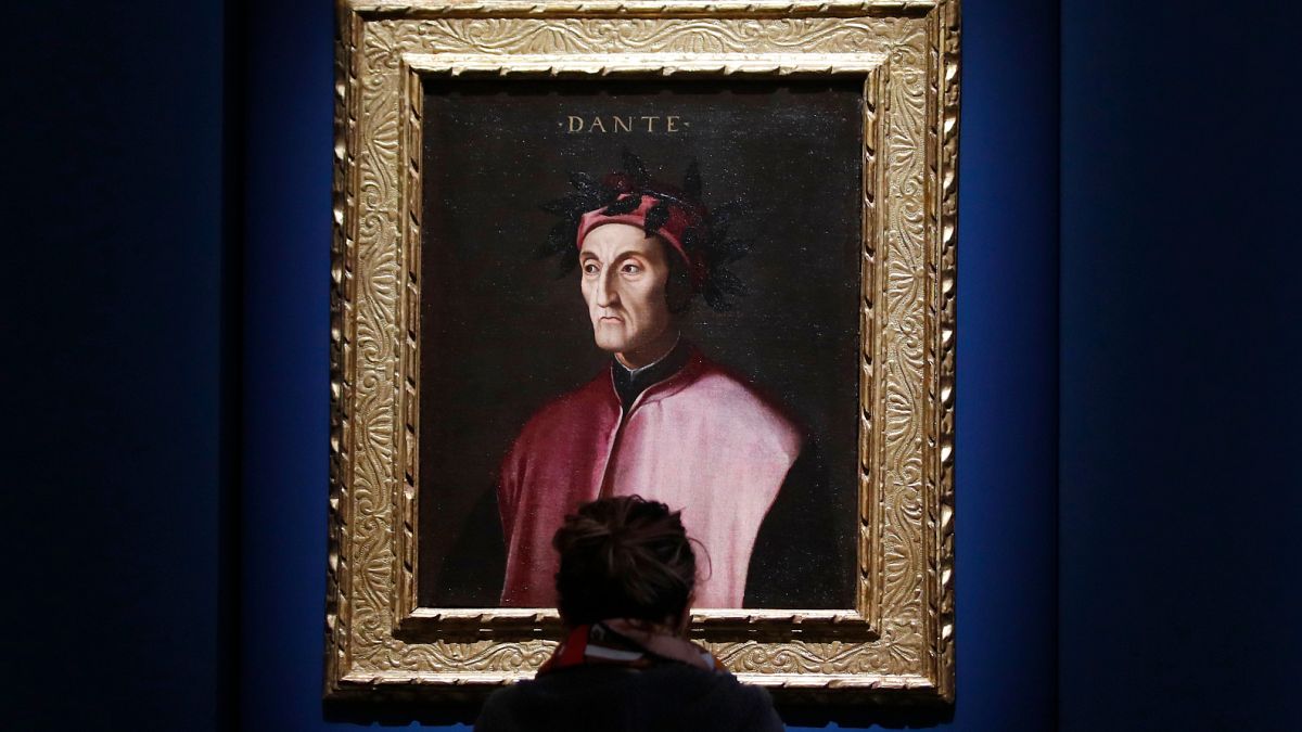 A woman looks at a portrait of poet Dante Alighieri at an exhibition, in Forlì, Italy, Saturday, May 8, 2021