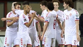 Denmark players celebrate a goal against Austria during their 2022 FIFA World Cup qualifying match.