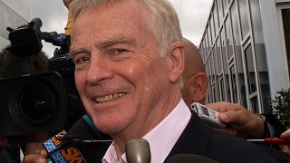 FIA President Max Mosley walks up the Paddock Lane surrounded by the media at the Silverstone circuit shortly before the start of the British Formula One Grand Prix Su