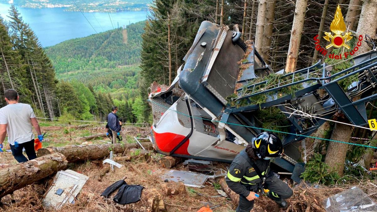 Rescuers work by the wreckage of a cable car after it collapsed near the summit of the Stresa-Mottarone line in the Piedmont region, northern Italy, Sunday, May 23, 2021.