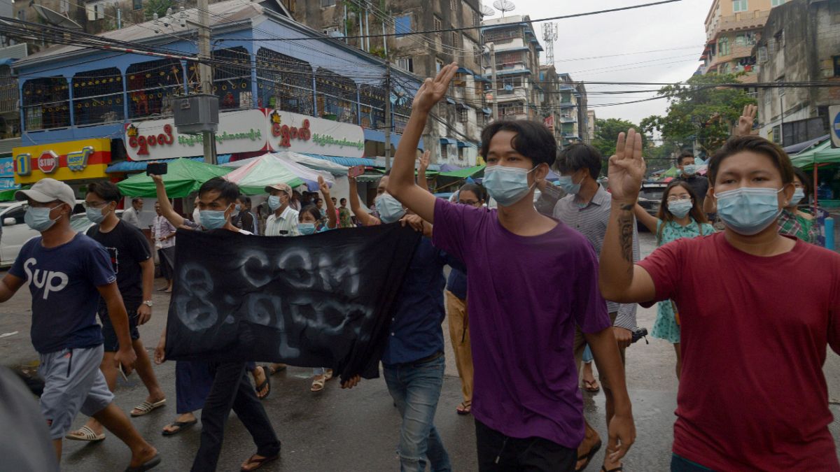 Anti-coup protesters flash the three-finger salute during a demonstration against the military takeover, in Yangon, Myanmar, Monday, May 24, 2021. 