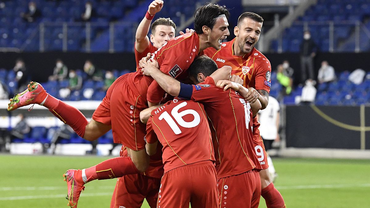 North Macedonia's players celebrate their first goal during a 2022 FIFA World Cup qualifying match against Germany.