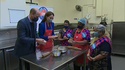 William and Kate in kitchen cooking next to stove