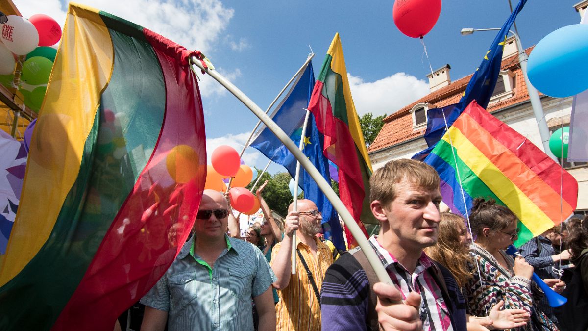 People hold flags and take part in the annual Baltic Gay Pride Parade in Vilnius, Lithuania, Saturday, June 18, 2016.