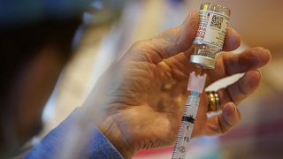 A healthcare workers fills a syringe with Moderna COVID-19 vaccine before administering it to emergency medical workers and health care personnel.