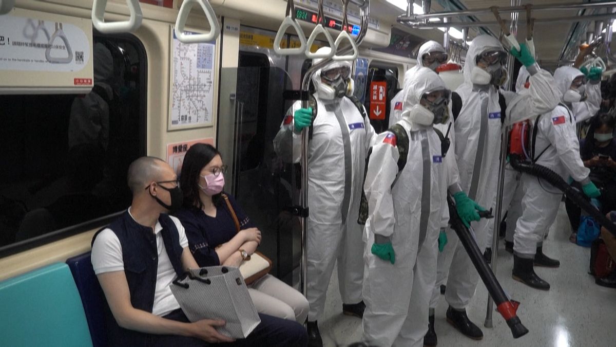 Soldiers wearing PPE ride the metro subway from station to station to disinfect