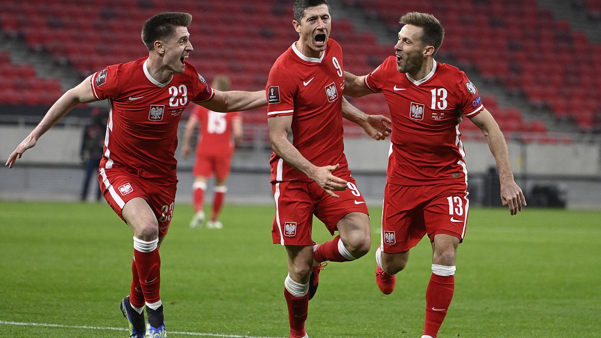 Robert Lewandowski celebrates after scoring Poland's third goal against Hungary during the 2022 FIFA World Cup qualifying match.