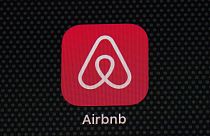 The Airbnb app icon is seen on an iPad screen