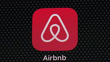 The Airbnb app icon is seen on an iPad screen