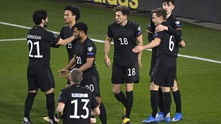 Germany's players celebrate during the 2022 FIFA World Cup qualifying match against Iceland.