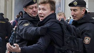 FILE - In this Sunday, March 26, 2017 file photo, Belarus police detain journalist Raman Pratasevich, center, in Minsk, Belarus.