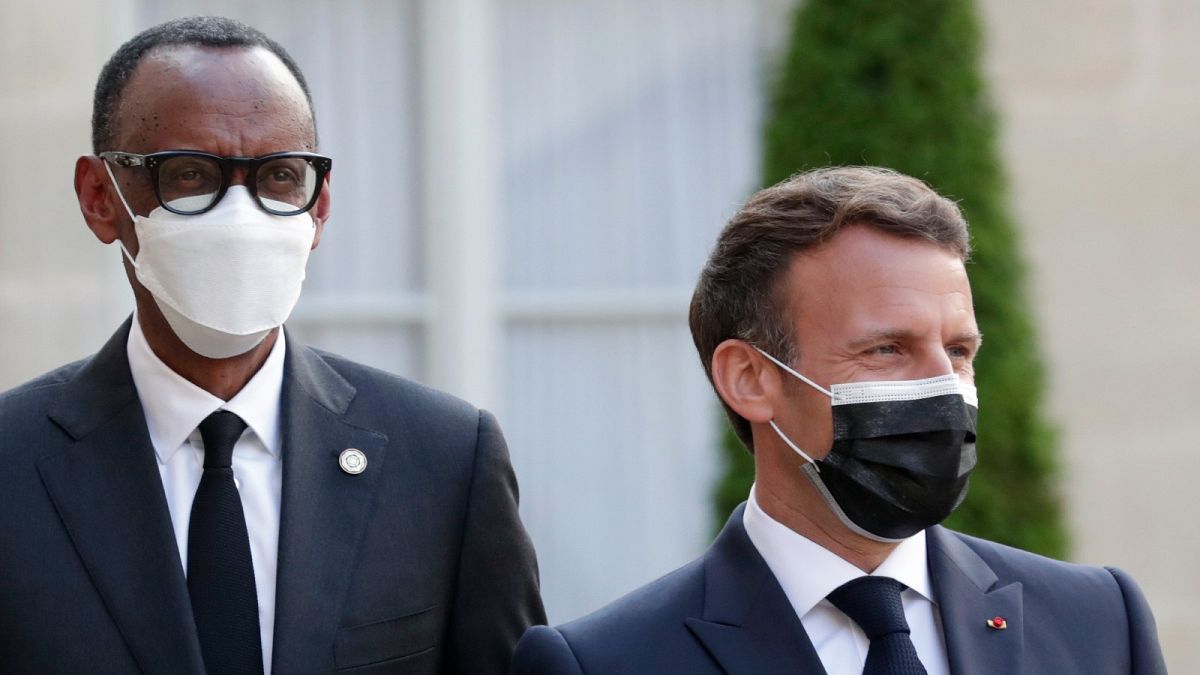 Before visiting Rwanda, French President Emmanuel Macron, right, welcomes Rwanda President Paul Kagame, with leaders of African states in Paris, Monday, May 17