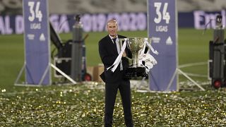 Real Madrid's head coach Zinedine Zidane, holds the trophy as he poses for the photographers after winning the Spanish La Liga 2019-2020.