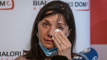 Mother of Roman Protasevich, Natalia Protasevich wipes tears from her eyes during a press conference in the Belarusian House Foundation in Warsaw