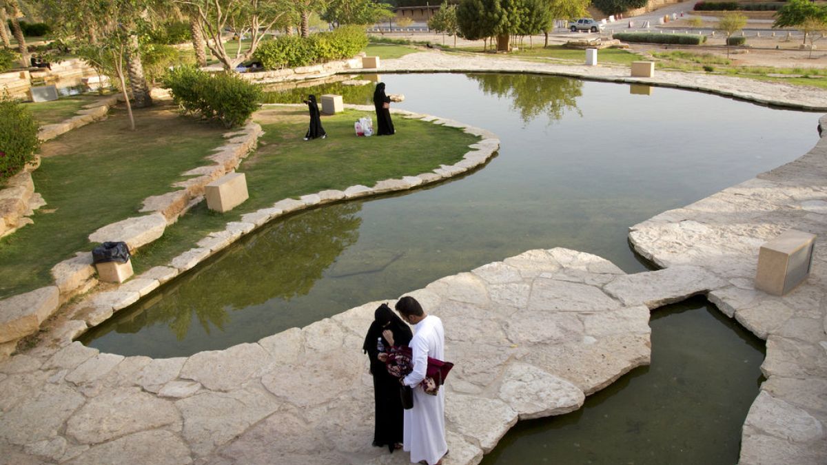 Visitors walk in a garden at the 18th century Diriyah fortified complex, that once served as the seat of power for the ruling Al Saud, in Riyadh, Saudi Arabia. 