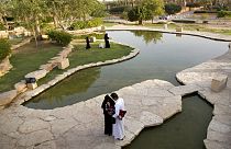 Visitors walk in a garden at the 18th century Diriyah fortified complex, that once served as the seat of power for the ruling Al Saud, in Riyadh, Saudi Arabia.
