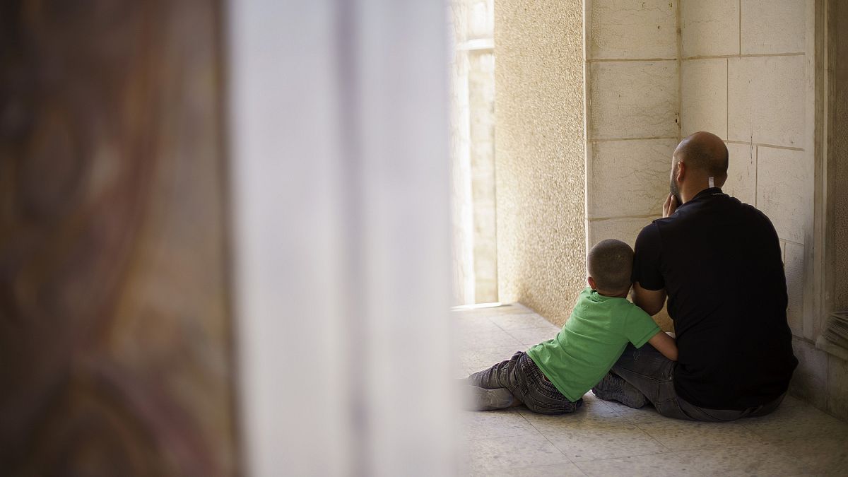 Un bambino palestinese abbraccia il padre 
