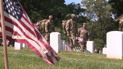 US soldiers place flags at Arlington National Cemetery ahead of Memorial Day