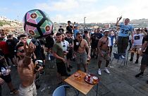 Manchester City supporters drink and chant by the Douro river bank in Porto, Portugal, Friday, May 28, 2021.