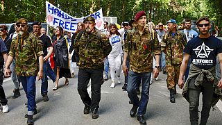 Protesters march from a Brussels park to the European Union headquarters on Saturday.