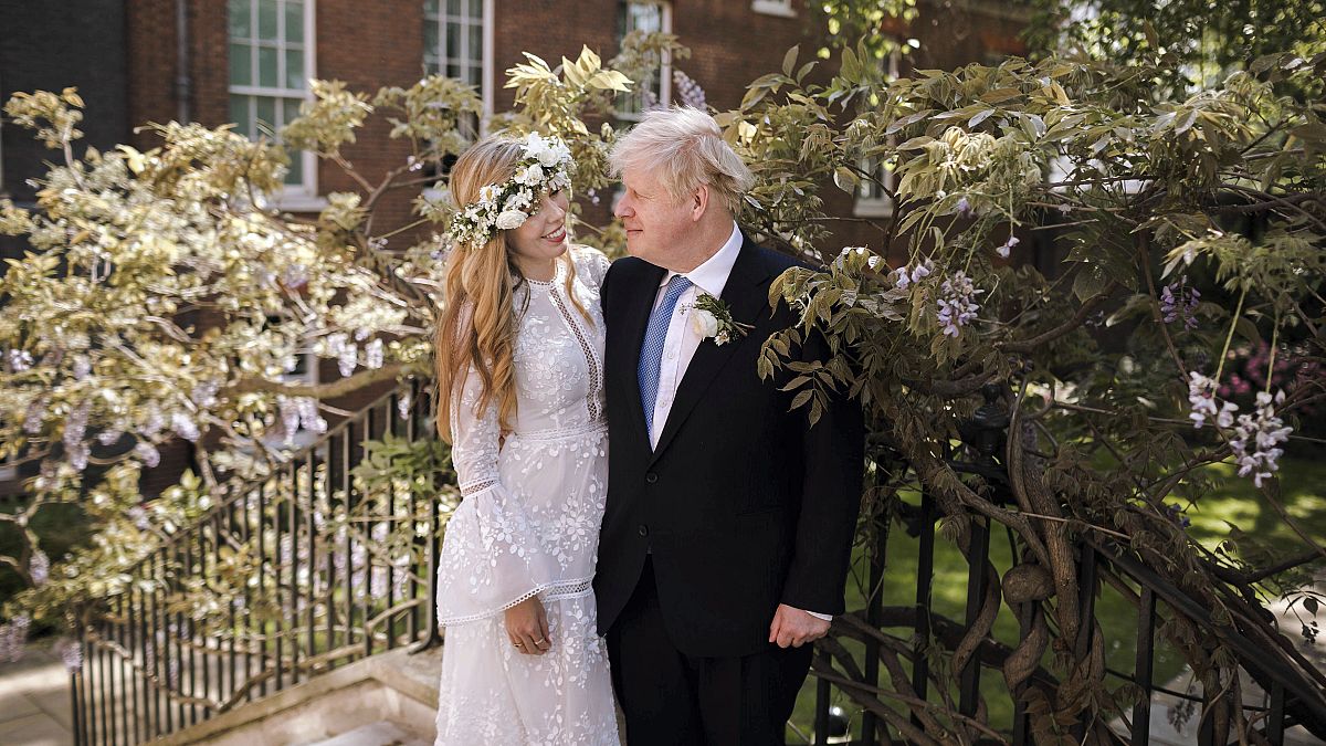Britain's Prime Minister Boris Johnson and Carrie Johnson pose together in the garden of 10 Downing Street after their wedding on May 29, 2021.