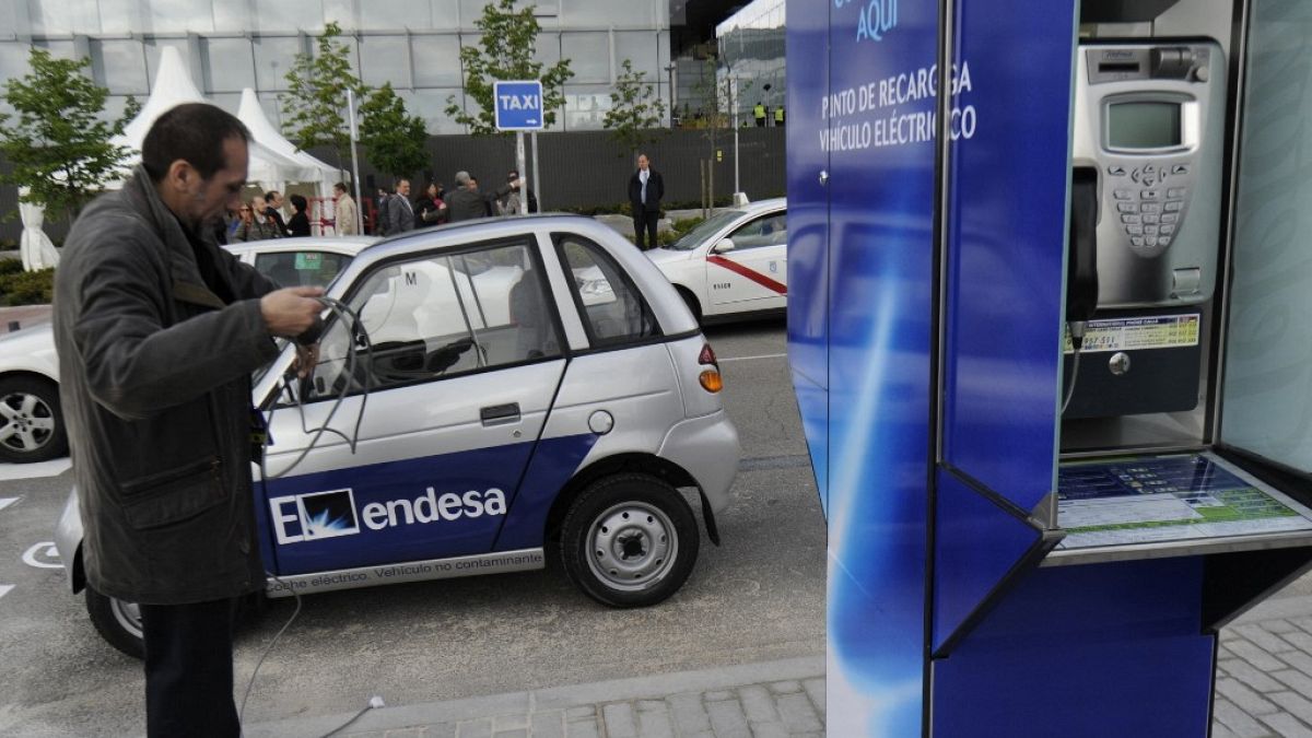 An electric car gets charged at the first Spanish telephone booth equipped to charge electric cars in Madrid