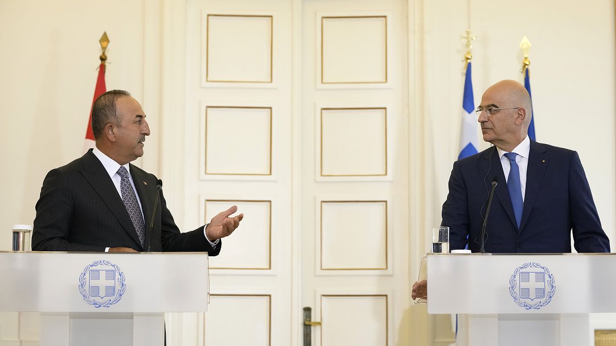 Greek Foreign Minister Nikos Dendias, right, and his Turkish counterpart Mevlut Cavusoglu 