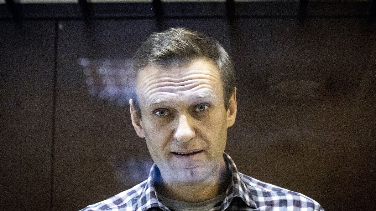 FILE - In this Saturday, Feb. 20, 2021 photo, Russian opposition leader Alexei Navalny looks at photographers standing in the Babuskinsky District Court in Moscow, Russia