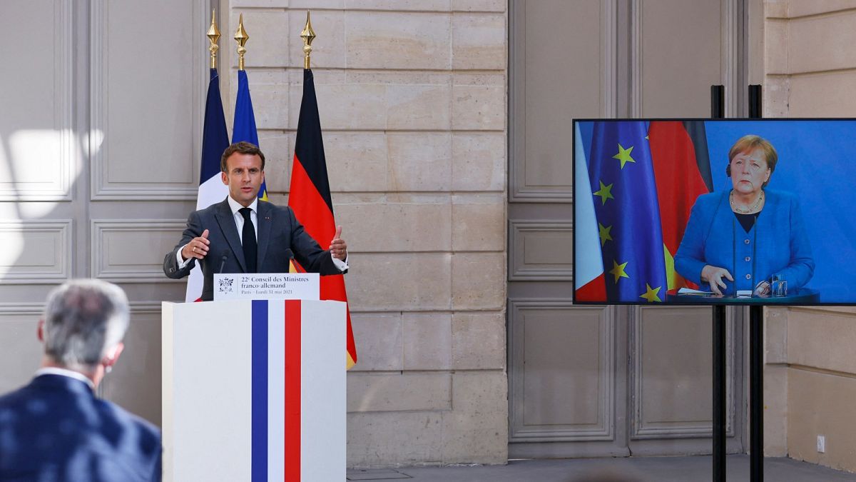 الرئيس الفرنسي إيمانويل ماكرون في مؤتمر صحفي مشترك مع المستشارة الألمانية أنجيلا ميركل في مؤتمر بالفيديو للمجلس الوزاري الألماني الفرنسي الثاني والعشرين،  باريس،  31 مايو 2021