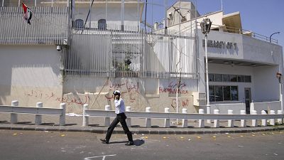 FILE: A policeman walks in front of the damaged US embassy after pro-government protesters attacked the embassy in Damascus, Syria, 2011 FILE: A policeman walks in front of the damaged US embassy after pro-government protesters attacked the embassy in Damascus, Syria, 2011