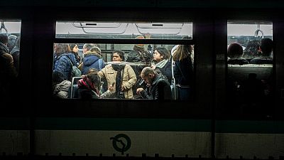 People commute in a metro in Paris