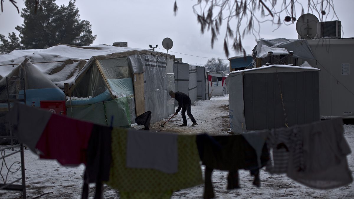 FILE: A Syrian refugee man clears the snow around his shelter at the refugee camp of Ritsona about 86 kilometres north of Athens, Wednesday, Jan. 11, 2017. 