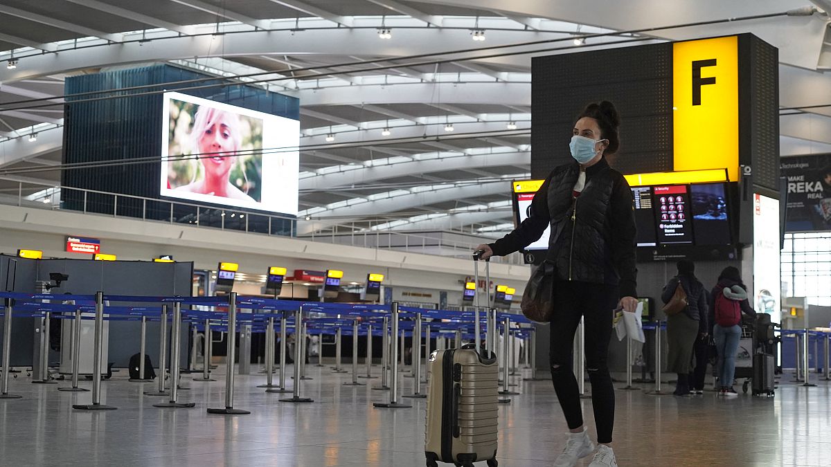 A passenger in the almost deserted departures hall at Terminal 5 of Heathrow Airport in west London on December 21, 2020.