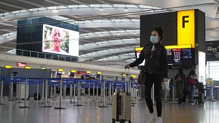 A passenger in the almost deserted departures hall at Terminal 5 of Heathrow Airport in west London on December 21, 2020.
