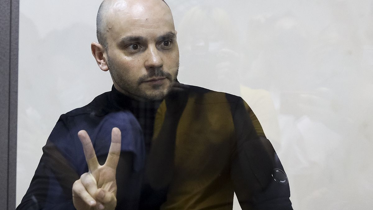 Andrei Pivovarov, the head of Open Russia movement gestures standing behind the glass during a court session in Krasnodar, Russia, Wednesday, June 2, 2021.