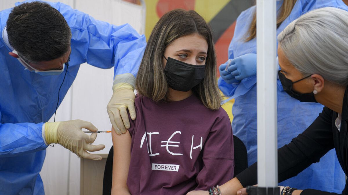 FILE Photo: A girl gets a Pfizer BioNTech COVID-19 vaccine in Bucharest, Romania, Wednesday, June 2, 2021. 