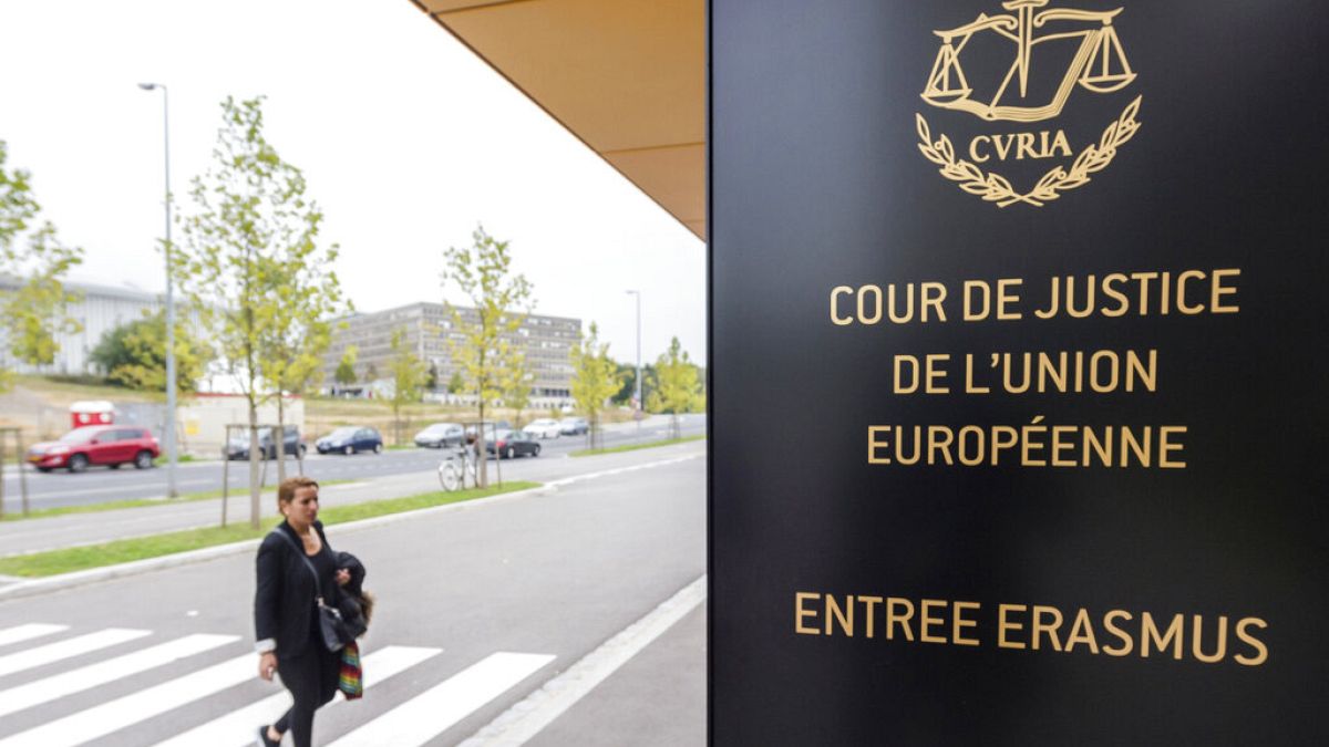 In this file photo taken on Monday, Oct. 5, 2015 a woman walks by the entrance to the European Court of Justice in Luxembourg.