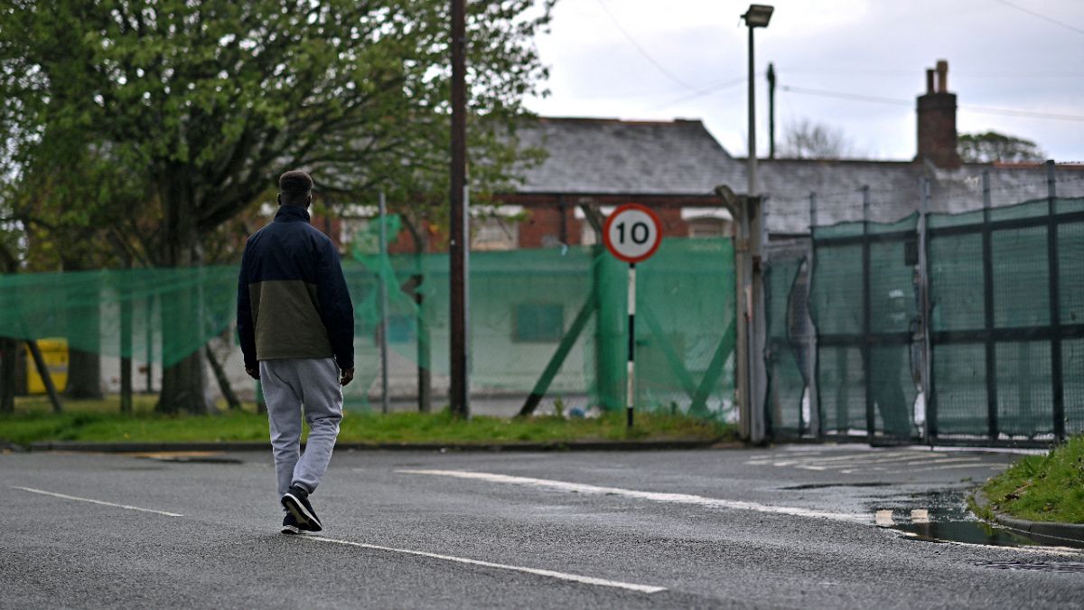 A resident of Napier Barracks, a former military barracks that is being used to house asylum seekers, returns on Folkestone, southeast England on May 22, 2021. 