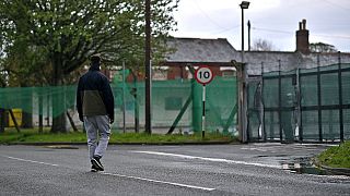 A resident of Napier Barracks, a former military barracks that is being used to house asylum seekers, returns on Folkestone, southeast England on May 22, 2021. 